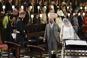 zzzzinte1 Britain's Prince Harry, Duke of Sussex (2nd L), looks at his bride, Meghan Markle, as she arrives accompanied by the Britain's Prince Charles, Prince of Wales in St George's Chapel during the wedding ceremony of Britain's Prince Harry, Duke of Sussex and US actress Meghan Markle in St George's Chapel, Windsor Castle, in Windsor, on May 19, 2018. / AFP PHOTO / POOL / Jonathan Brady zzzz