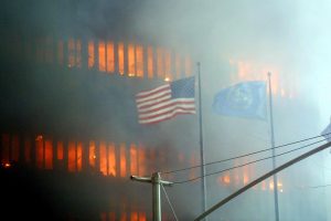 ****inte1An American flag flies in the foreground as one of the World Trade Center towers burns in the background 11 September 2001 in New York.  Two hijacked airplanes crashed into the two landmark skyscrapers.  AFP PHOTO/Doug KANTER ****