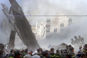 A group of firefighters stand in the street near the destroyed World Trade Center in New York on September 11, 2001. Two hijacked U.S. commercial planes slammed into the twin towers of the World Trade Center on Tuesday, causing both 110-story landmarks to collapse in thunderous clouds of fire and smoke.   REUTERS/Shannon Stapleton