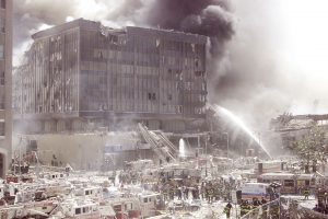 A group of firefighters work to put out fires in what is left of the destroyed World Trade Center in New York on September 11, 2001. Two hijacked U.S. commercial planes slammed into the twin towers of the World Trade Center early on Tuesday, causing both 110-story landmarks to collapse in thunderous clouds of fire and smoke. REUTERS/Shannon Stapleton