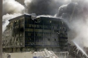 A group of firefighters work to put out fires in what is left of the destroyed World Trade Center in New York on September 11, 2001. Two hijacked U.S. commercial planes slammed into the twin towers of the World Trade Center early on Tuesday, causing both 110-story landmarks to collapse in thunderous clouds of fire and smoke. REUTERS/Shannon Stapleton