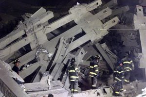 A group of firefighters search the remains of the destroyed World Trade Center in New York on September 11, 2001. Two hijacked U.S. commercial planes slammed into the twin towers of the World Trade Center early on Tuesday, causing both 110-story landmarks to collapse in thunderous clouds of fire and smoke. REUTERS/Shannon Stapleton