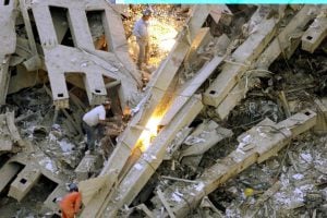 ****inte1Rescue workers use torches in their search for survivors in the debris of the World Trade Center twin towers collapse early 12 September 2001 in New York City.  Both tower of the World Trade Center collapsed after hijacked airliners collided with them 11 September.   AFP PHOTO/Marcos TOWNSEND****