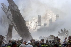 A group of firefighters stand in the street near the destroyed World Trade Center in New York on September 11, 2001. Two hijacked U.S. commercial planes slammed into the twin towers of the World Trade Center on Tuesday, causing both 110-story landmarks to collapse in thunderous clouds of fire and smoke.   REUTERS/Shannon Stapleton