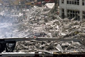 Workers dig in the wreckage of the World Trade Center as it lies accross West Street in New York City  September 12, 2001. The World Trade Center towers were destroyed after being struck by commercial planes in a terrorist attack on September 11.  REUTERS/Mike Segar