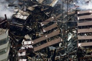 The collapsed remains of the 7 World Trade Center continues to burn in lower Manhattan three days after a terrorist attack in the center in New York, September 14, 2001. The World Trade Center Towers and 7 World Trade Center were all destroyed after both the landmark towers were struck by two planes in a terrorist attack on September 11.  REUTERS/Mike Segar